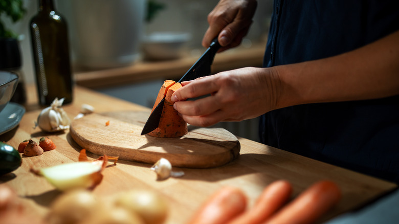 Chopping vegetables on cutting board