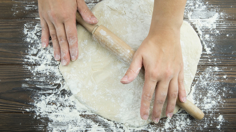rolling pizza with rolling pin