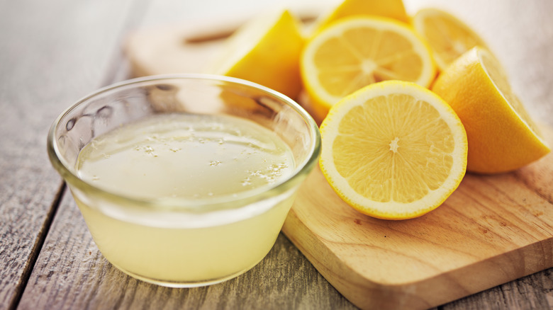 Cup of lemon juice and cut lemon halves