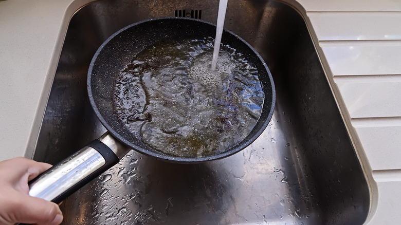 Dish sink with running water on pan