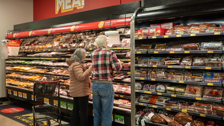 Customers shopping for meat at the grocery store