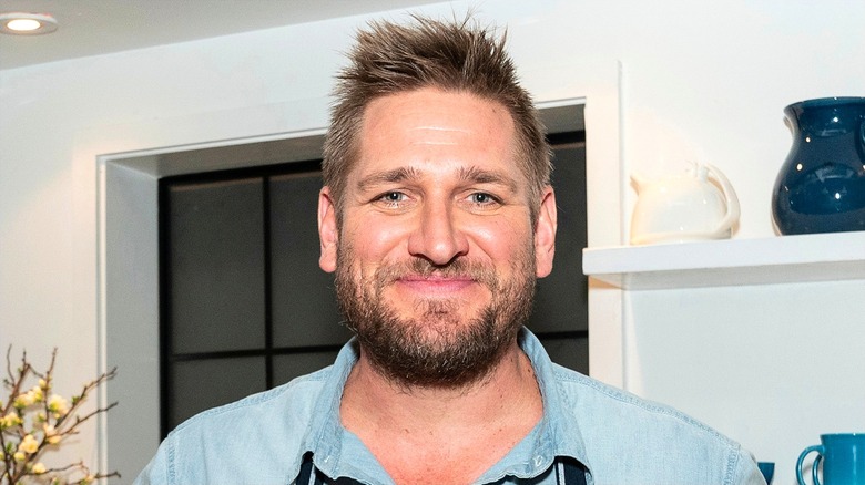 Curtis stone with facial hair smiling