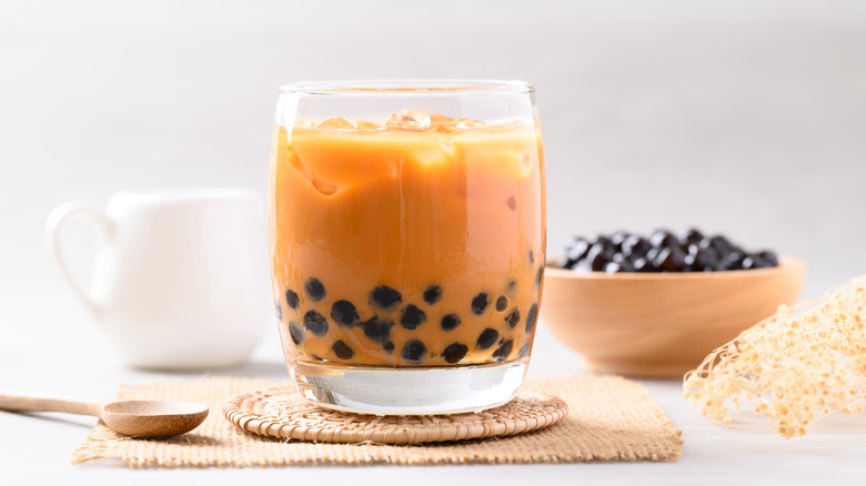 Iced Thai milk tea with boba or Thai bubble tea in glass on white background