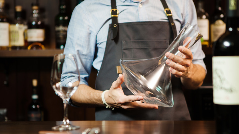 Man holding a clean wine decanter