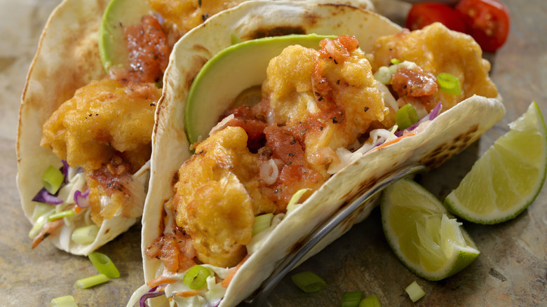 Beer battered cauliflower tacos are topped with fresh salsa, avocado, and slaw