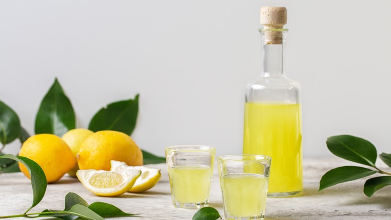 Bottle of limoncello and fresh lemons