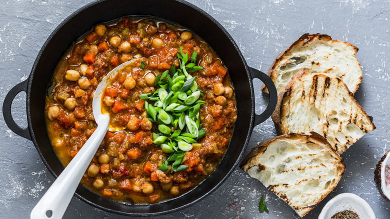 A pot of bean stew with bread