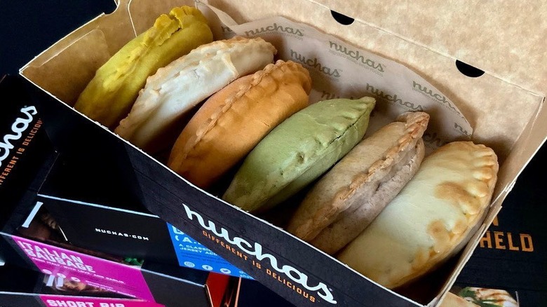 Six Nuchas empanadas in a box