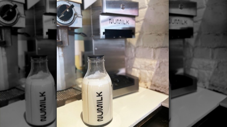 A bottle of Numilk with the Pro machine