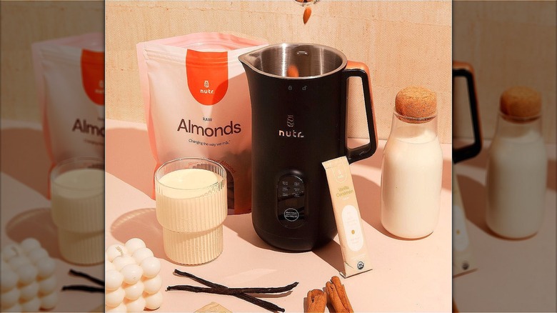 Black Nutr machine with a Nutr flavoring packet and Nutr branded almonds