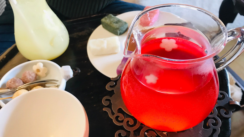 A jug of bright red omija tea