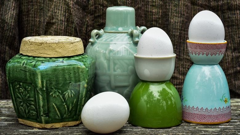 a variety of antique egg coddlers
