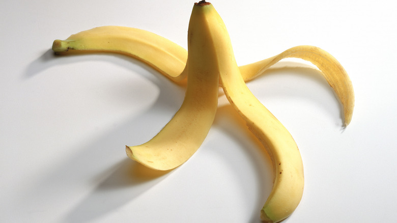 banana peeled and splayed out on white surface