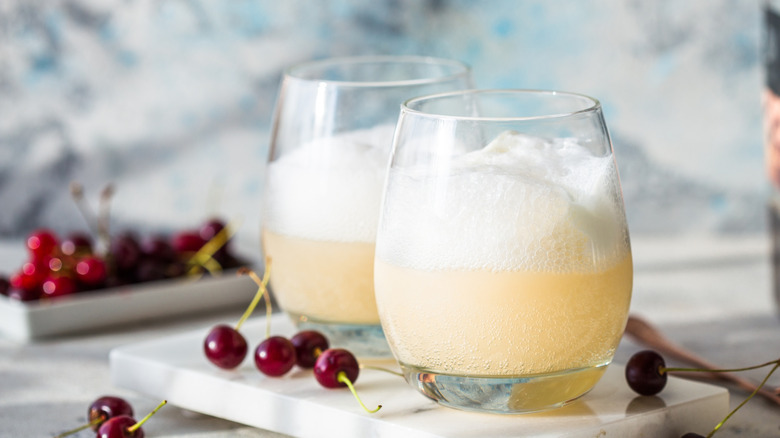 two glasses of creamsicle cocktail on marble slab