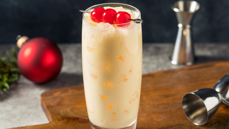 Snowball cocktail in collins glass with cherries