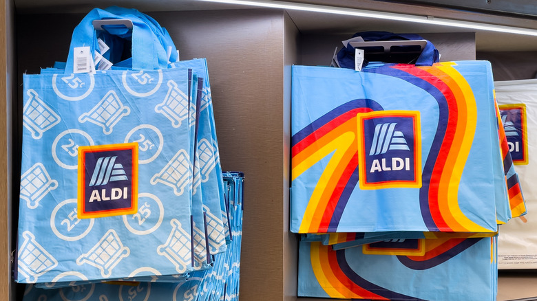 Aldi shopping bags on display inside an Aldi