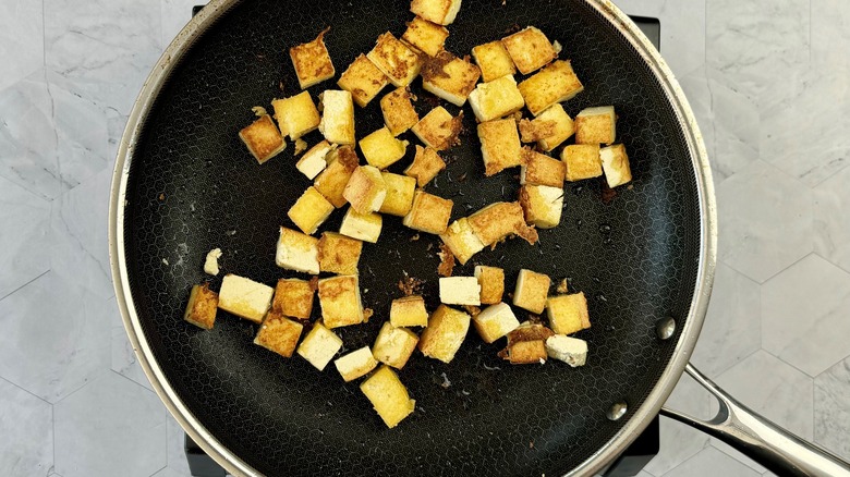fried tofu chunks in pan