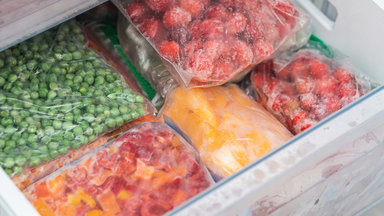 Bags of frozen fruits and vegetables in the freezer