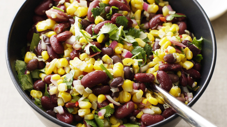 Bowl of black and kidney beans, corn, onions, and cilantro