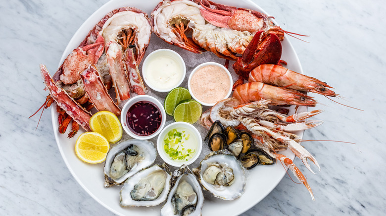 Seafood platter with oysters, lobster, prawns, dips