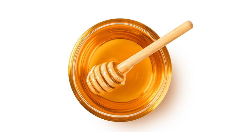 Jar of honey with honey spoon