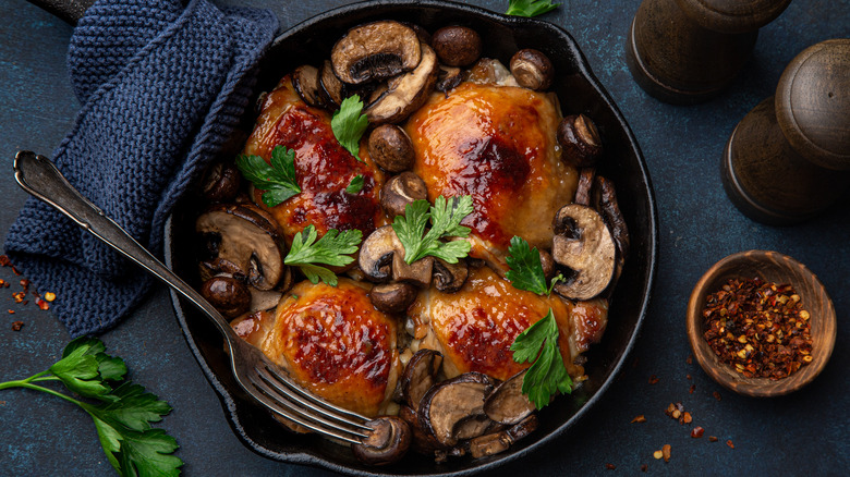 chicken and mushrooms in a cast iron skillet