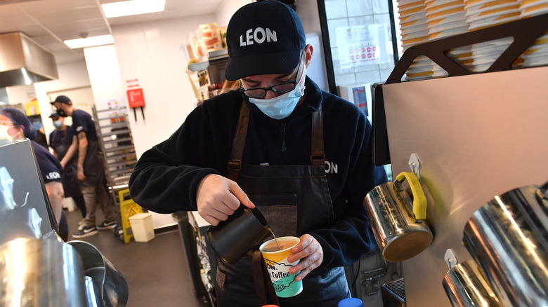 Fast food employee preparing coffee beverage