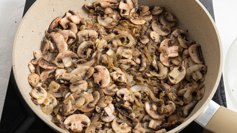 Cooked mushrooms and onions in pan