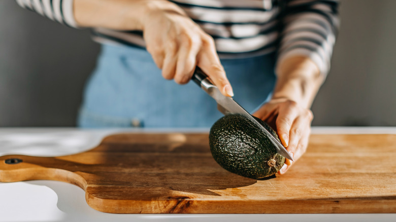 Women cutting an avocado