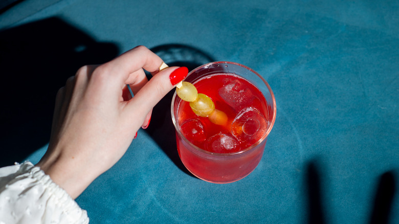 An orange after dinner cocktail, with fruit used as a garnish.