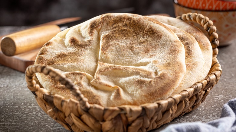 Pita bread in a bread basket on table