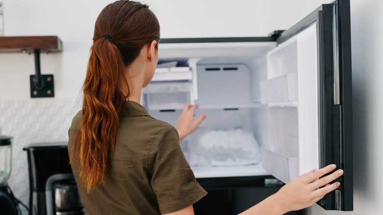 Woman looking into her freezer