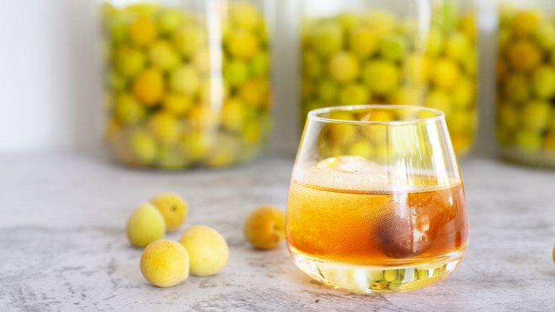 Glass and jars of plum wine