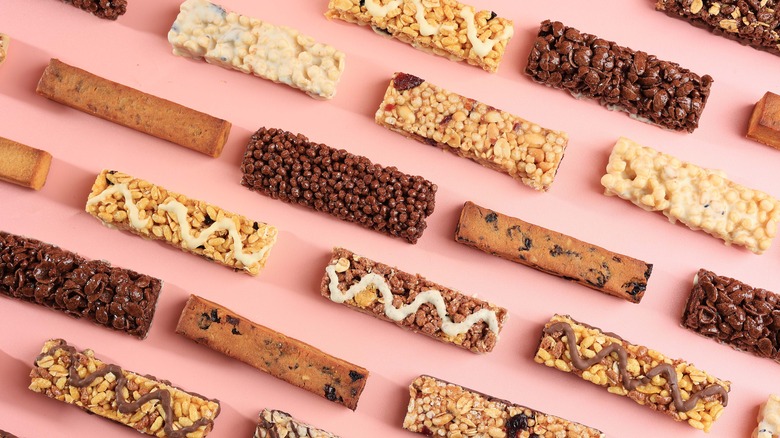 Assorted granola bars on pink background