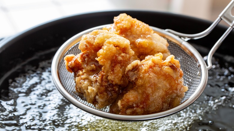 japanese fried chicken over a pot of oil