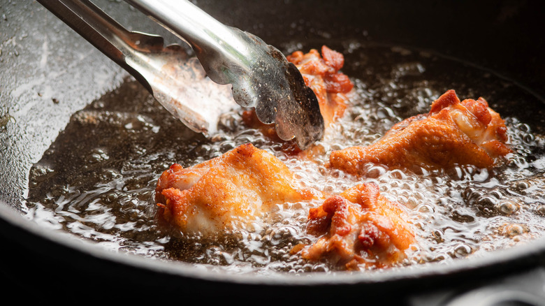 drumsticks frying in a pan