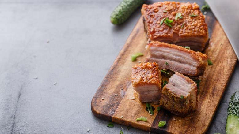 roast pork belly on cutting board