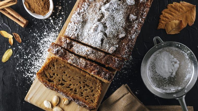 Sliced pumpkin bread loaf with powdered sugar