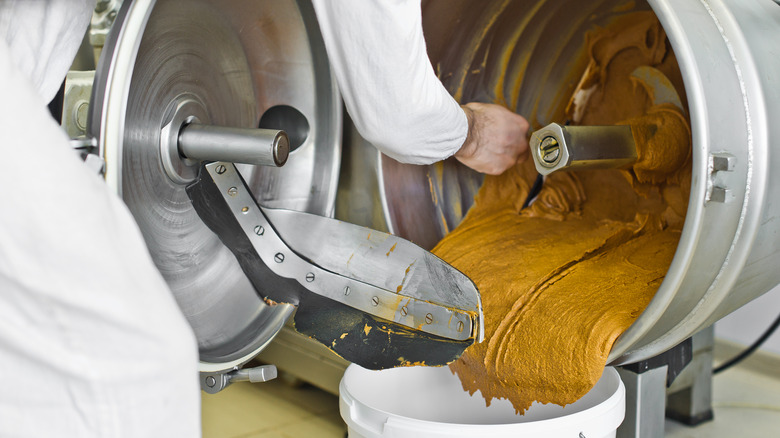 Making large batch of peanut butter in industrial machine