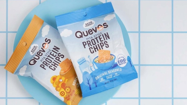 Two bags of Quevos chips on a blue plate