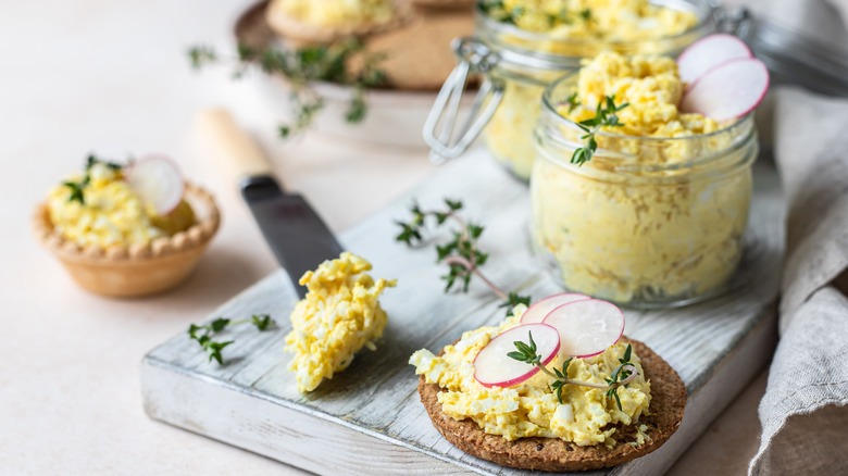 Egg salad spread on cracker