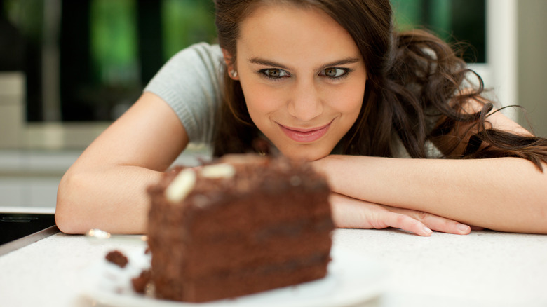 woman staring at cake slice