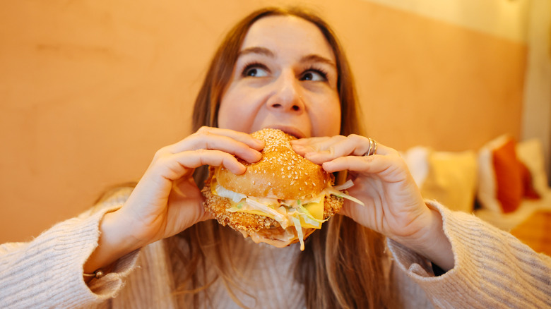 woman eating chicken sandwich