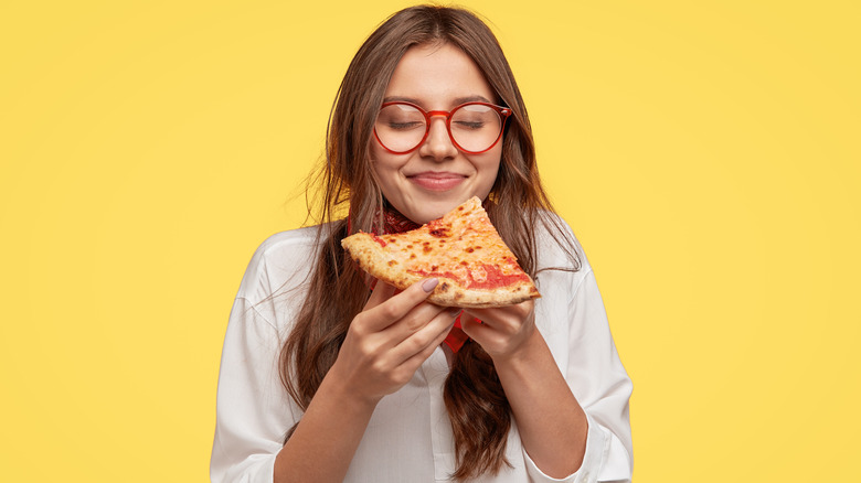 Woman eating cheese pizza