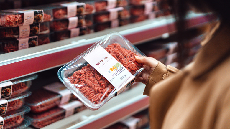 Person looking at packaged ground beef