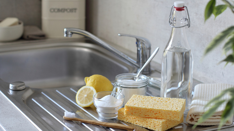 Baking soda, lemon, and vinegar on a kitchen sink