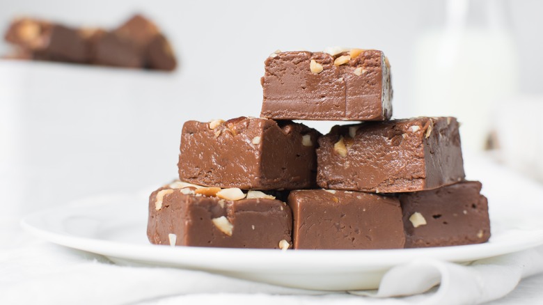 Chocolate fudge with nuts on a white plate