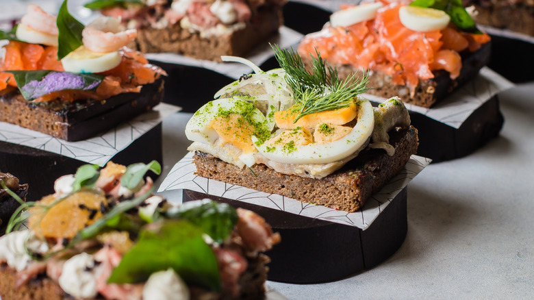 Multiple open-faced sandwiches with various toppings