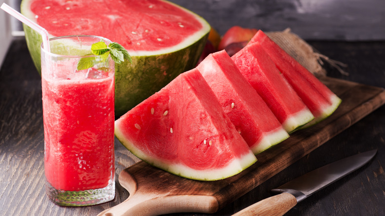 slice of watermelon next to a watermelon drink 