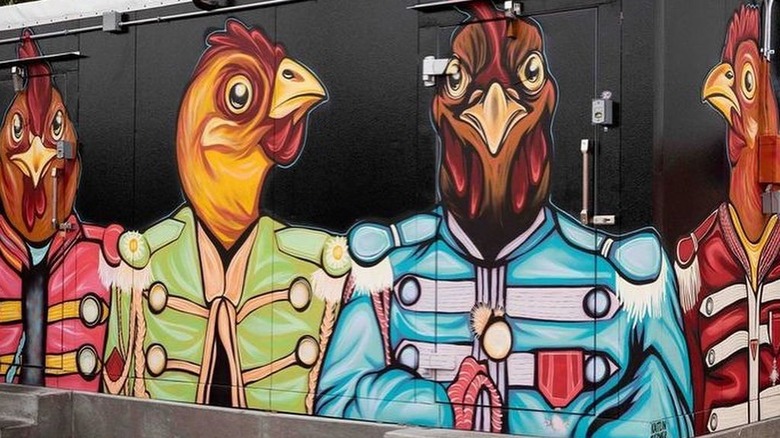 Mural of chickens wearing Sergeant Pepper outfits painted on Birdcall building